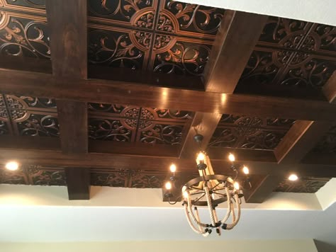 The Florence Ceiling Tile from our Legacy Series along with wood beams and a rustic chandelier make an amazing ceiling.  #ceilingtiles #ceiling #ceilingideas #woodbeams #rustic Creative Ceilings Ideas, Copper Ceiling Tiles Kitchen, Tin Ceiling Ideas Rustic Kitchen, Ornate Ceiling Design, Modern Ceiling Beams, Wood Beams On Ceiling, Speakeasy Vibes, Creative Ceiling Ideas, Ceiling Tile Ideas