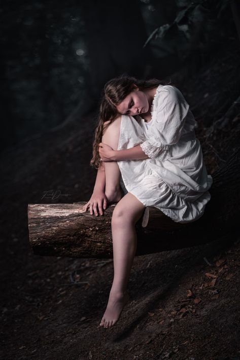 Girl sitting on a tree in the forest wearing a white sleepinggown Melancholy Poses Reference, Person Sitting With Legs Dangling, Sitting On Tree Pose, Dramatic Sitting Pose, Sitting In A Dress Reference, Sitting Poses Dress, Sitting Dress Pose, Dress Sitting Reference, Person Hunched Over Reference