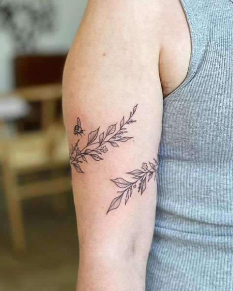 Greenery Wrap Tattoo, Vine Tattoo Bicep, Tattoo Ideas Female Bicep, Wrap Around Tattoo Design, Fine Line Botanical Tattoo, Bee Flower Tattoo, Botanical Wrap Tattoo, Bee And Flower Tattoo, Bicep Tattoo Women