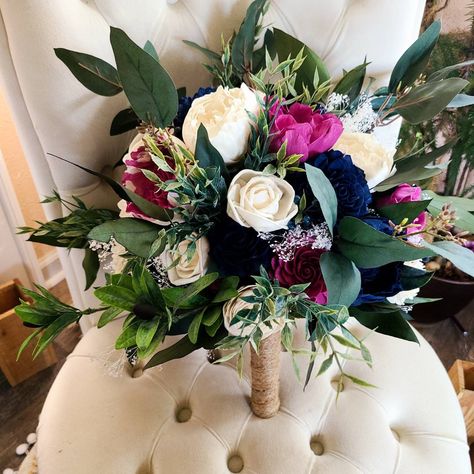 This gorgeous sola wood flower bouquet features a mix of faux greenery and beautiful bright pink and dark blue flowers.  Pictured bouquet is 10 inches in diameter. To purchase matching boutonnieres, look here: https://www.etsy.com/shop/mydinosaurdreams/?section_id=21264911 To purchase matching corsages, look here:  https://www.etsy.com/shop/mydinosaurdreams/?section_id=21264913 **Sola Flowers** *Sola flowers are hand-made from a soft wood (similar to balsa) and as such, each is unique!  They fee Dark Blue And Pink Bouquet, Navy And Dark Pink Wedding, Navy And Pink Flowers, 2024 Prom Flower Trends, Bright Wedding Bouquet Summer, Small Prom Bouquet, Nosegay Bouquet For Prom, Homecoming Flowers Bouquet, Homecoming Bouquet Ideas