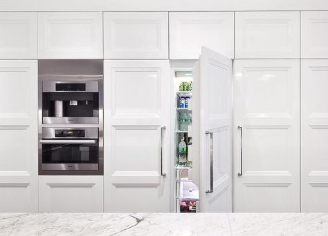 A wall of kitchen cabinets surround a hidden French doors refrigerator next to a Miele coffee maker stacked atop a pull out Miele microwave. Hamptons Decor, Kitchen Wall Cabinets, Single Wall Oven, Hidden Kitchen, Light Hardwood Floors, Kitchen Pantry Cabinets, Tiny Space, St Charles, Tiny Spaces