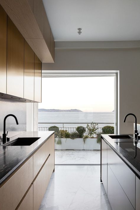 Modern kitchen with wooden cabinets and a view of the sea through a large window. www.fiori.com.au #kitchens #kitchenideas #modernkitchendesign #kitchendesign #kitchendesignideas #kitchenlayout #kitchenrenovationideas #kitchenrenovation #kitchenrenovationideasSydney #kitchendesigntrends #kitchendesignlayout Kitchen With Wooden Cabinets, Latest Kitchen Designs, White Marble Floor, Kitchen Surfaces, Large Window, Kitchen Designs Layout, Kitchen Design Trends, Exclusive Furniture, Naples Italy