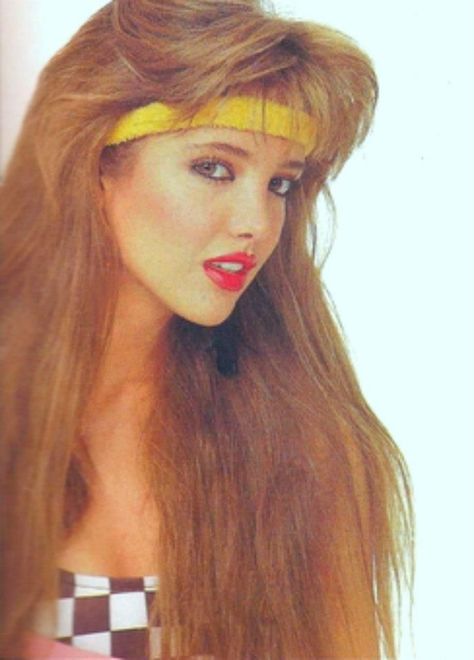 a photo of actress Adela Noriega from the 1980s; she has feathered bangs and long, warm blonde hair and a yellow headband/sweatband; she has red lips and a checkered top 80s Makeup And Hair 1980s Hairstyles, 80s Rock Hair Women, 1980’s Makeup, 80s Hair Tutorial, Eighties Hair, 1980s Hairstyles, 80s Rock Hair, 1980s Glamour, 80s Makeup Looks