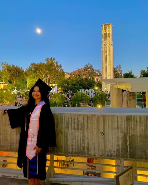 university of california, riverside graduation commencement.graduate is wearing regalia and is standing in front of the UCR Bell Tower. The moon in sagittarius is bright in the sky. Uc Riverside Aesthetic, University Of California Riverside, Uc Riverside, University Graduation, One Day I Will, University Of California, Dream Life, University, California