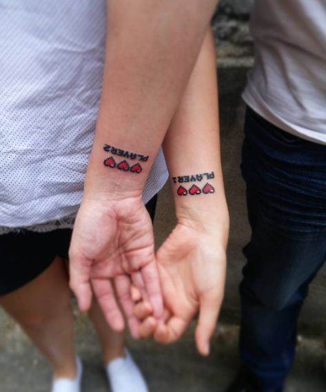 couple tattoos ideas gallery Gamer Couple Tattoos Ideas, Gaming Couple Tattoos, Gamer Couple Tattoos, Playstation Tattoo, Couple Tattoos Ideas, Matching Love Tattoos, Pixel Tattoo, Best Couple Tattoos, Small Matching Tattoos