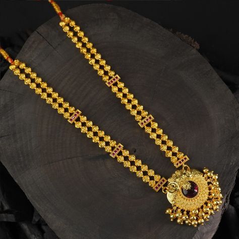 Two layer necklace design with an gold look-a-like pendant studded with a red stones The handmade ghugroos add a elegant look to it . Whatsapp - 9403830260 #tanmani #tanmaninecklace Two Layer Necklace, Kolhapuri Saaj, Peacock Pendant, Red Stones, Traditional Jewellery, Layer Necklace, Necklace Design, Traditional Jewelry, Red Stone