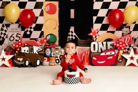 Boys first birthday car themed cake smash photoshoot Cars Birthday Photo Shoot Ideas, Race Car Themed Photoshoot, Pixar Cars Birthday Photoshoot, Lighting Mcqueen Photoshoot, Race Car 1st Birthday Photoshoot, Race Car First Birthday Photoshoot, Cars Smash Cake Disney, Cars Photoshoot Kids, Disney Cars Photoshoot