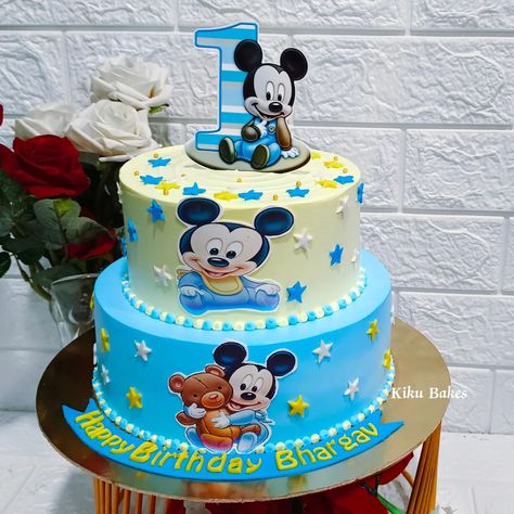 Baked with love 💕 Celebrate your little one's first birthday in style with our delightful two-tier Black Forest cake, adorned with a charming Mickey Mouse theme. The bottom tier features a vibrant blue hue, while the top tier is adorned with cheerful yellow color, perfectly capturing the spirit of Mickey's world. Adorned with fondant stars in blue, yellow, and white, the cake sparkles with magic. At the center of each tier, an edible photo of Mickey Mouse brings the beloved character to life... Fondant Stars, Tire Cake, Mickey 1st Birthdays, Mickey Mouse Birthday Cake, Baked With Love, Mickey Mouse Theme, Mickey Mouse Cake, Black Forest Cake, Order Cake