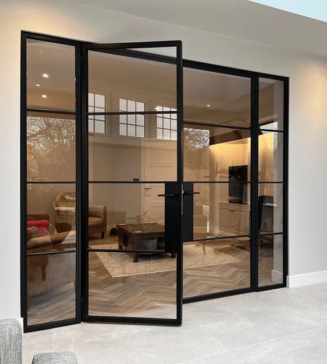 Affordable Elegance with Black Aluminium Crittall Style Doors: Elevate your home's interior and exterior with the timeless appeal of Crittall style doors. This blog post offers practical tips on how to incorporate these sleek, black aluminium doors into your space, ensuring luxury and style on a budget. Ideal for homeowners looking for a high-end look with affordability. Large Crittal Doors, Black Metal Office Door, Black Frame Door Exterior, Crittall Style Doors, Black Crital Doors, Black And Glass Doors Interior, Black Glass Metal Door, Black Paned Glass Wall, Glass Wall Black Frame