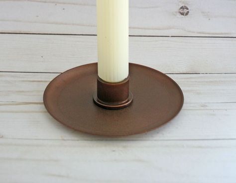 There is something about tall candles on a dining room table. They instantly add a level of sophistication.Have you seen the ceramic taper candle holders that look like plates? The ones that aren’t raised off the table, but sit directly on it? They hold those tall candles.I love their simplicity. But they cost a little more than I want to spend.So I decided to create a version of them myself. I don’t do ceramics, thus I needed to be a little creative.This is my version of the ceramic-l… Diy Tall Candle Holders, Diy Candlestick Holders, Diy Taper Candle Holders, Diy Candle Stick Holder, Tapper Candles, Tall Candle Holder, Tall Candles, Diy Candle Sticks, Fall Centerpieces