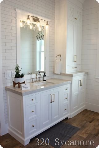 white bathroom wood floors Bathroom Wood Floors, Modern Coastal Farmhouse, Grey And White Bathroom, Farmhouse Tour, Wood Floor Bathroom, Mudroom Cabinets, Bathroom Wood, White Marble Bathrooms, Full Bathroom Remodel