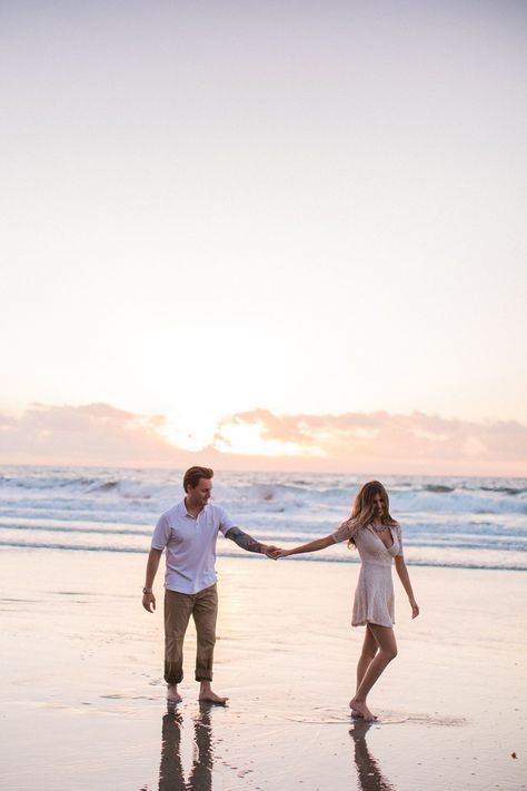 engagement picture, photo of ocean, sunset photoshoot, couple dancing in san diego, california khaki pants white shirt pink dress beach picture Pink Dress Beach, Engagement Pictures Beach, Couples Beach Photography, Couple Beach Pictures, Couple Beach Photos, Sunset Photoshoot, Beach Photo Session, Photos Bff, Photoshoot Couple