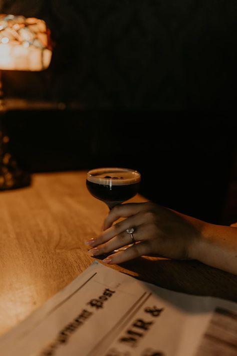 A couple enjoying drinks at a bar, engagement newspaper closeup. This couple's editorial bar engagement shoot in Tennessee were so moody and romantic! See tons of moody engagement photos, dark and moody engagement shoot and classy bar engagement photos. Book Mataya to capture your Tennessee engagement pictures at matayabuck.com! Moody Bar Engagement Photos, Moody Romantic Engagement Photos, Pub Engagement Photos, Cocktail Bar Engagement Photos, Cocktail Editorial, Speakeasy Engagement Photos, Engagement Newspaper, Engagement Photos Dark, Edgy Engagement Pictures