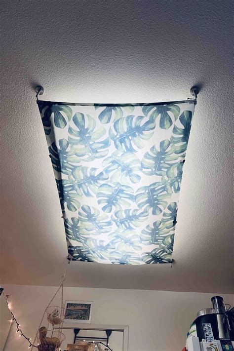 Diy Fabric Fluorescent Light Covers Cover Fluorescent Lights, Fluorescent Light Covers Diy, Florescent Light Cover, Diy Lantern Lights, Painting Light Fixtures, Flourescent Light, Fluorescent Light Covers, Apartment Lighting, Light Fixture Covers