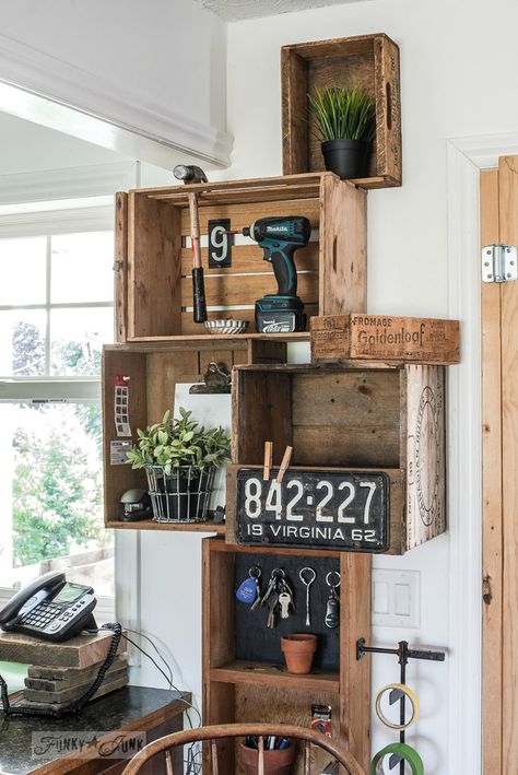 Stacked vintage crates and a reclaimed wood shelf for a rustic kitchen phone station against white walls. | funkyjunkinteriors.net Wood Crates Shelves, Vintage Crate Decor, Wooden Crates On Wall, Wood Crate Decor, Kitchen Chairs Diy, Crate Shelves Bathroom, Crates On Wall, Farmhouse Kitchen Chairs, Wooden Crate Shelves