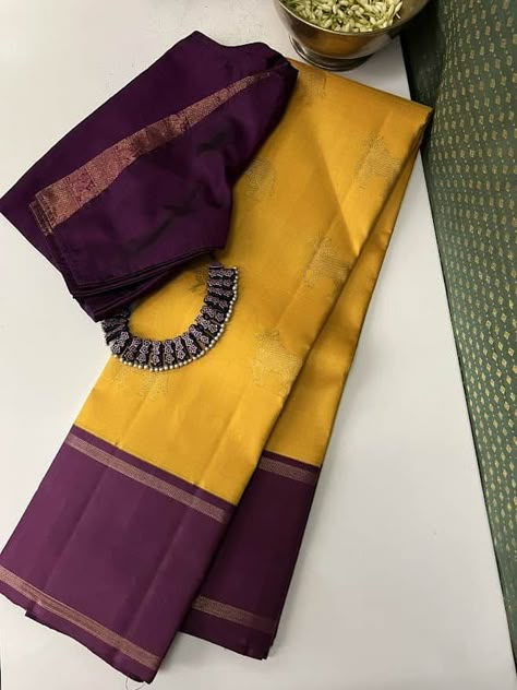 Pure kanchipuram silk saree woven in the korvai style , this saree is a signature Aavaranaa creation. The body has the kamdhenu motifs woven in pure zari, the border is kept simple but the pallu is richly woven in a traditional pattern with mythological figures and other smaller patterns like rudrakshams. This is a bright mustard yellow with deep mauve border. The blouse piece is plain border colour Yellow Colour Saree Contrast Blouse, Organza Banarasi Saree, Saree Combination, Saree Yellow, Katan Saree, Saree Styling, Kanchi Sarees, Kanjeevaram Sarees, Saree Kanchipuram