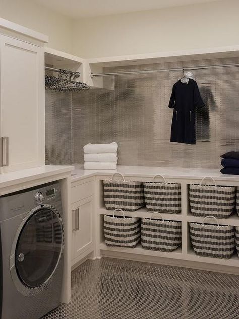 Contemporary laundry room features ivory shaker cabinets paired with white quartz countertops and mini stainless steel tili backsplash. Unfinished Basement Laundry, Contemporary Laundry Room, Laundry Room Storage Shelves, Room Storage Diy, Basement Laundry Room, Dream Laundry Room, Basement Laundry, Laundry Room Layouts, Modern Laundry Rooms