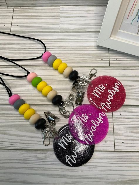 Teachers, put your pencils up and accessorize your teaching style with our Personalized Teacher Lanyard! 🍎✏ This back-to-school season, let's celebrate you with this stylish, practical, and custom gift. With its full 21” length, black glitter circle, and silicone pencil beads, it’s a showstopper! Don’t forget, there's no refunds or exchanges, so ensure accuracy in your personalization. Go ahead, make a statement! Your classroom awaits 🔖 #TeacherAppreciation #CustomizedGifts#shopsmallbusiness ... Lanyard Teacher, Gray Trim, Teacher Lanyard, Back To School Essentials, Christmas School, Teaching Style, Beaded Lanyards, Gifts For Teachers, Silicone Beads