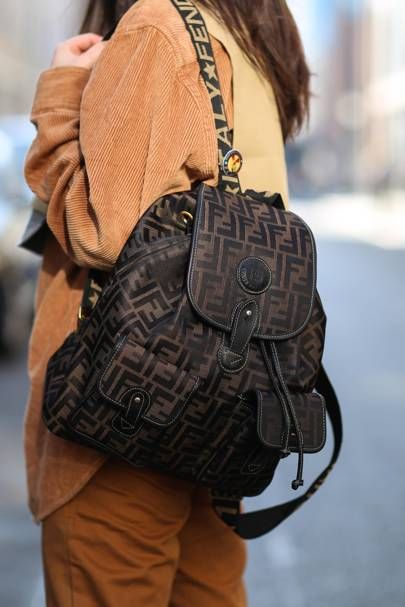 Street style: The Best New Ways To Wear A Backpack. | British Vogue Branded Backpacks, Fendi Backpack, Transitional Fashion, Luxury Backpack, Backpack Outfit, Street Style Bags, Attention Seeking, Fall Trends Outfits, Chanel Backpack