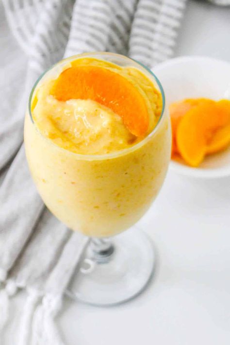 Start your day off right with this fresh and fruity peaches and cream smoothie! This delicious, creamy beverage is a perfect way to get some fruits in early, kick-start your morning energy levels, and satisfy your sweet tooth. Why You Will Love This Recipe With only five ingredients – frozen peaches, yogurt, pinch of cinnamon, honey & milk – thissmoothie comes together quickly in the blender – no advanced culinary Peaches And Cream Smoothie, Morning Energy, Frozen Peaches, Honey Milk, Cinnamon Honey, Kid Approved Meals, Frozen Dessert Recipe, Creamy Smoothies, Yogurt Flavors