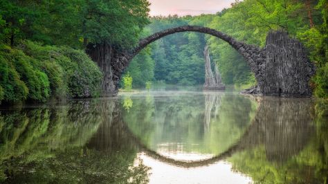 Rakotzbrücke (Rakotz Bridge), Gablenz, Saxony  Hidden in Kromlau's Rhododendron Park, Rakotzbrücke is a 19th-century bridge that creates a perfect stone circle when reflected in the waters below it. Hotels In France, Germany Trip, Zhangjiajie, Plitvice Lakes National Park, Lake Bled, Plitvice Lakes, Travel Germany, Ulsan, Places In Europe