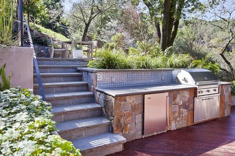 The multilevel deck features a hot tub, outdoor kitchen and beautiful hillside landscaping with a miniature waterfall fountain. Photo: OpenHomesPhotography.com / SF Hillside Backyard, Miniature Waterfall, Hillside Landscape, Pool Landscape Ideas, Hot Tub Landscaping, Beamed Ceilings, Deck Features, Sloped Yard, Sloped Backyard