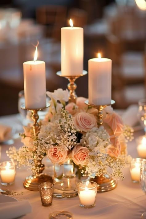 Candle centerpieces create a warm, inviting glow on wedding tables. Click for more inspiration. Gold Candlestick Wedding Centerpieces, Candle Labra Centerpieces, Toffee Rose Centerpiece, Candle And Flower Centerpieces Wedding, Elegant Centerpieces Wedding, Candelabra Centerpiece Wedding, Wedding Centerpieces Gold, Candlestick Centerpiece Wedding, Candle Centrepiece