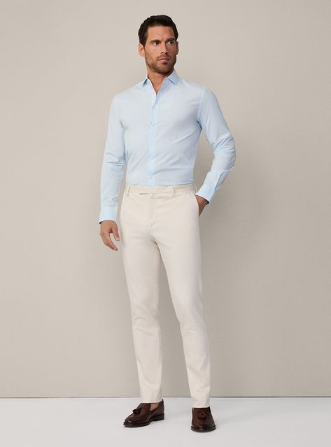 A stylish, season-appropriate outfit with a light blue dress shirt and beige pants, beautifully complemented by dark brown loafers. Perfect for creating a polished yet comfortable look for any day event.