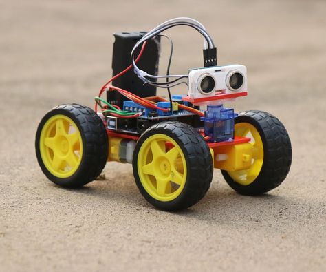 How to Make Obstacle Avoiding Car Using Arduino: Hey guys in this project I have made an Obstacle avoidance car that uses arduino, This robotic car will automatically avoid going in the path of any obstacles! How cool is that?  This robot car serves as an ultimate source of learning if you are will… Arduino Robot, Portable Tv, Robotics Projects, Electronics Mini Projects, Car Projects, Electronics Projects, Arduino, Electronics