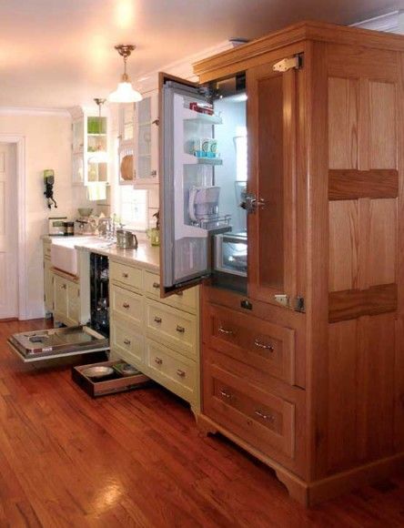 What appears to be a restored, vintage icebox is actually a three-sided cabinet of oak paneling built by the homeowner to conceal a modern refrigerator. The dishwasher, too, is hidden in cabinets. Photo by Bill Ticinito. Vintage Kitchen Art, Modern Refrigerator, Vintage Kitchen Appliances, Refrigerator Panels, Outdoor Kitchen Appliances, Appliances Design, Victorian Kitchen, Arts And Crafts House, Oak Panels