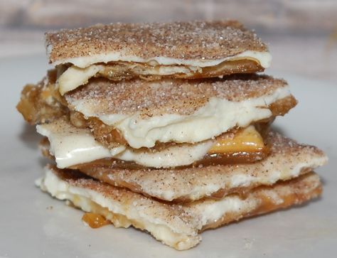 First a baking sheet is lined with parchment paper. Then saltine crackers are placed in a single layer. Next in a saucepan melted butter and brown sugar are cooked until boiling, then poured over the crackers. The pan bakes in the oven until the brown sugar mixture bubbles. White chocolate chips are sprinkled on top then left to melt, then spread into an even layer. Then a cinnamon sugar is sprinkled on top. Once the chocolate is set the mixture is broken into pieces and served.