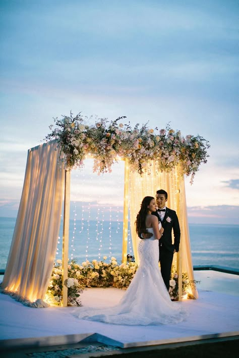 How unreal is Thailand for a destination wedding location?! We are sharing all the pastel beauty from this Phuket ceremony overlooking the ocean, with draped pinks, lush floral arrangements and string lights overflowing. Modern meets romance all the way down to the whimsical cake display with cascades of geometric shapes. Check out the full story on #ruffledblog Wedding Altar Decorations, Sunset Beach Weddings, Dream Beach Wedding, Phuket Wedding, Thailand Wedding, Wedding Altars, Wedding Stage Decorations, Outdoor Wedding Decorations, Wedding Stage