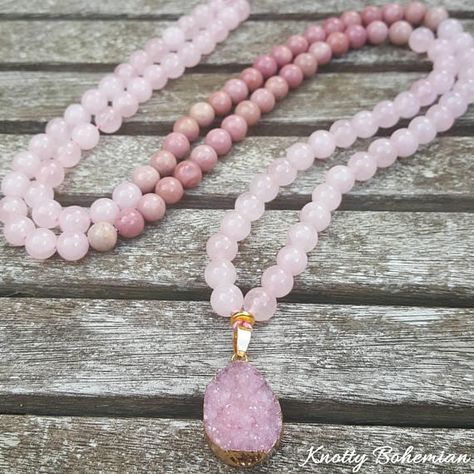 Beautiful beaded 108 pink gemstone dipped mala necklace with 8mm Rose Quartz, Rhodonite beads and a pink druzy pendant.  Beaded on thick pink thread and ended in the back with a bow knot and a cute little nickel and lead free charm in gold by the USA brand TierraCast.  Will go around your neck once.  OTHER INFORMATION All jewelry comes from a smoke free and cat loving home. The cat stays away from my beads though!  If you have any questions regarding this necklace, do not hesitate to send me ... Pink Natural Stones Beaded Necklace For Healing, Handmade Pink Necklaces For Meditation, Adjustable Pink Gemstone Beads Necklace, Pink Spiritual Necklace With Faceted Beads, Pink Rose Quartz Spiritual Beaded Necklace, Pink Thread, Healing Gemstone Bracelets, Mala Bead Necklace, Crystal Jewelry Sets