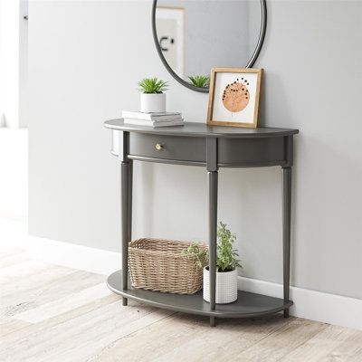 Give your living room or entryway a glow-up with a beautiful new Half-Moon Console Table. The classic elegance of the half-moon top and tapered legs create a vintage yet sophisticated feel perfect for any décor. This half-moon Console Table features a spacious drawer to keep clutter out of sight and a lower shelf for books, photos, or other decorative items to cozy up the room. Made sturdy painted MDF, the Console Table is as durable as it is affordable and assembly is a snap! With the preassemb Small Entry Tables, End Of Hallway, Shelf For Books, Half Moon Table, Half Moon Console Table, Small Console Table, Console Table With Drawers, Mirrored Console Table, Wood Accent Table