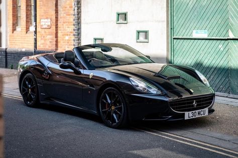 A sleek, all-black example of Ferrari’s stylish convertible grand tourer. Ferrari California Black, Black Convertible Car, Ferrari Convertible, Black Ferrari, Black Convertible, Dream Car Garage, Ferrari California, 2025 Vision, Pretty Cars