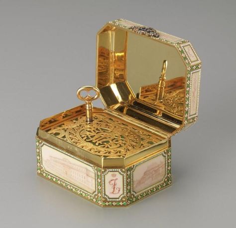 In 1907 Felix and Nikolai Yusupov gave this Fabergé music box to their parents, Prince Felix and Princess Zenaida, as a twenty-fifth wedding anniversary present. Six of the Yusupov palaces are depicted in sepia enamel panels. When opened, the music box plays "The White Lady" by François Boieldieu, the march of the senior Prince Felix's regiment, the Imperial Horse Guards. Antique Music Box, Wedding Anniversary Presents, Prince Felix, Music Box Vintage, Musical Box, Music Jewelry, Faberge Eggs, Objet D'art, Music Box