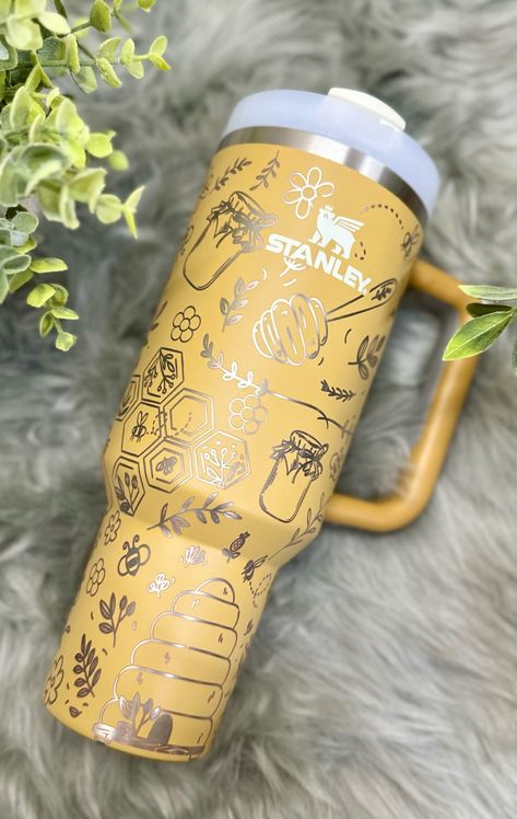 Brand New 30 or 40 oz Stanley Quencher Tumbler engraved with our super cute bee design! Each Stanley is removed from its original packaging in order to engrave it with a beautiful floral wrap. If you would like to add in personalizations, such as names or dates, please send us a message and we can make it happen! Adventure Series 90% recycled 18/8 stainless steel, BPA-free Recycled stainless steel icon inside the tumbler indicates your Quencher is made from sustainable materials Double-wall vacu Stanley Tumbler, Stanley Quencher, Tumbler With Handle, 40oz Tumbler, Cute Cups, Bee Design, Floral Wraps, Reusable Straw, Stanley Cup