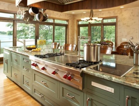 The working side of the large island features a range top, induction cooktop, prep sink and refrigerator drawers for the ultimate gourmet kitchen.  #interiordesign #kitchen #kitchenisland #greencabinetry #customkitchenhood #rangetop #prepsink #inductioncooktop #potrack #lakeview #lakehome #gourmetkitchen #refrigeratordrawers #customcabinetry Kitchen Island With Cooktop, Kitchen Island With Stove, Island Cooktop, Kitchen Island With Sink, Unique Kitchen Design, Large Kitchen Island, Gourmet Kitchens, Kitchen Pictures, Kitchen Islands