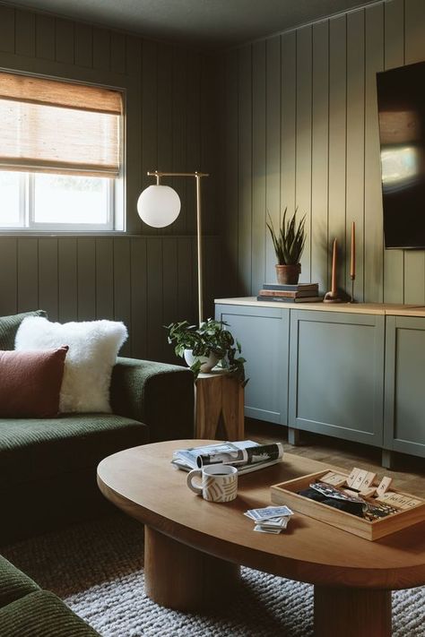 Dark Green Media Room, Cozy Basement Paint Colors, Moody Basement Paint Colors, Dark Paint Living Room, Dark Scandinavian Living Room, Dark Moody Basement, Moody Basement Ideas, Dark Basement Ideas, Green Basement