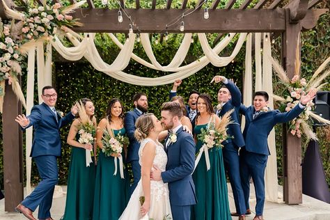 Mixing Greens and Blues for the Perfect Color Palette | Friar Tux Navy Suit Emerald Dress, Fall Wedding Colors Rustic Navy Blue And Grey, Navy And Green Wedding Party, Navy Suit Green Dress, Navy And Green Bridal Party, Navy Emerald Wedding, Navy And Emerald Wedding, Cloud Wedding, Suits Green