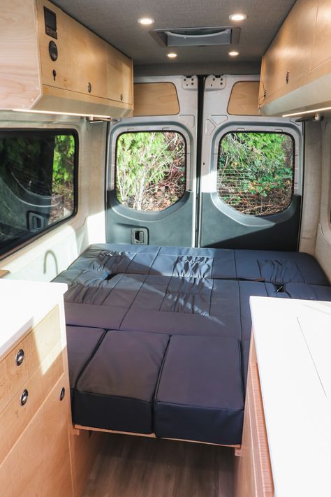 Sojourn - Freedom Vans Sprinter 144 Conversion, Corian Sink, Kitchen Galley, Laminate Plank Flooring, Converted Vans, King Sized Bed, Single Burner, Stainless Steel Microwave, Ottoman Cushion