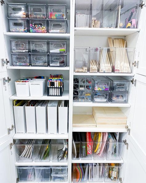 Consider using clear containers or labeled bins to easily identify contents. Storage solution from @tidybyco Work Office Organization Hacks, Gift Organization Storage, Back Office Organization, Art Supplies Storage Shelves, Stationery Cupboard Organisation, Aesthetic Craft Storage, Art Cabinet Organization Storage Ideas, Craft Organization Cabinet, Clear Storage Ideas