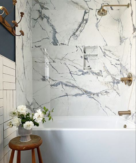 Large scale tile, marble shower wall, tub and shower combo renovation, mixing tiles, modern nautical Large Tiles Around Bathtub, Large Scale Porcelain Tile, Large Format Tile Small Bathroom, Marble Look Porcelain Tile Bathroom Shower Walls, Marble Tub Shower Combo, Marble Bathtub Shower Combo, Solid Slab Shower Walls, Quartz Slabs For Shower Walls, Quartzite Shower Walls