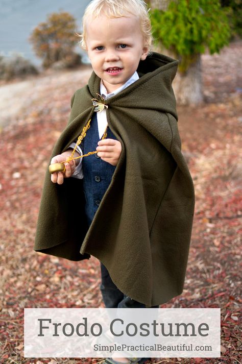 A Frodo costume for a toddler, including a glowing sword, a cloak, and the one ring | Halloween costume | Hobbit from The Lord of the Rings Frodo Costume Kids, Hobbit Costume Toddler, Hobbit Cloak Diy, Hobbit Cloak Pattern, Toddler Hobbit Costume, Lord Of The Rings Family Costumes, Baby Hobbit Costume, Diy Hobbit Costume, Captain America Toddler Costume