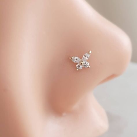 "⚡️ FREE SHIPPING ⚡️ on Domestic orders over $35 🇺🇸 🦋 Dainty and feminine, our 14k gold & Diamond CZ Butterfly nose stud is sure to be a favorite! * T H E * D E T A I L S *  * Solid 14K Gold with Cubic Zirconia accents * Choose from 14k Yellow or White Gold * Butterfly measures 5mm x 4.2mm * Post is 20 gauge * Thoughtfully packaged & ready for gift giving! * Handmade, just for you, in our sunny California Studio * Our 365 Guarantee: Our jewelry is guaranteed for 1 year after purchase date against defects. * Your body jewelry is sent in a gloss white jewelry box & our signature \"Studio Blue\" satin drawstring pouch, (shown in the last photo). * RETURN * POLICY * DETAILS * Items that cannot be returned:  * EARRINGS * BODY JEWELRY * SALE ITEMS  * CUSTOM ITEMS (including but not limited to Fun Nose Studs, Butterfly Nose Stud, Cute Nose Rings Studs, Nose Piercing Jewelry Studs, Nose Piercing Stud Diamond, Feminine Nose, Butterfly Nose Piercing, Nose Stud Jewelry, Cute Nose Studs