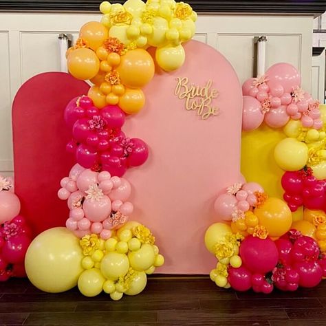 Add an exuberant festive flair to your bridal shower with a perky backdrop arrangement. Accentuate a Chiara backdrop stand with pink, fuchsia, and yellow backdrop covers for a contemporary look. For an added touch of vibrancy, opt for fuchsia, orange, pink, and yellow balloons as well as decorate your backdrop with fuchsia, orange, pink, and yellow flowers for a lasting cohesive appeal. Pink Yellow White Balloon Garland, Pink And Yellow Backdrop, Event Decor Ideas, Chiara Backdrop, Party Decorations Table, Yellow Backdrop, Backdrop Stands, Elegant Gift Wrapping, Bridal Shower Backdrop