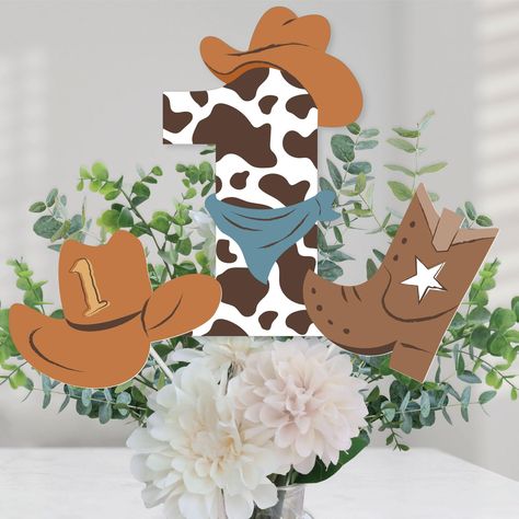 PRICES MAY VARY. My First Rodeo Table Toppers Includes 15 centerpiece cut-outs in 3 different shapes, 15 sticks, and stickers for easy assembly, and are a great addition to any Western 1st Birthday Party. Party Must-Have: The Western centerpiece cut-out SIZE 5 “1” Shapes - 6.75 inches wide x 10.75 inches tall, 5 Cowboy Boot Shapes – 5 inches wide x 6 inches tall, and 5 Cowboy Hat Shapes - 7 inches wide x 5 inches tall. Easy Table Decor: The Western party table decorations can be used as centerpi My First Rodeo Party, Cowboy 1st Birthday Party, Cowboy First Birthday, Western Table, Rodeo Birthday Parties, Wild West Party, Rodeo Party, Cowboy Baby Shower, My First Rodeo