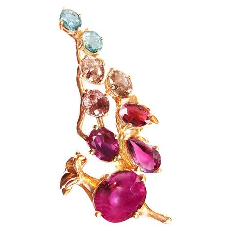 This Tobacco Flower brooch is made of 18 karat rose gold. The natural gems are: Oval ruby 4,27 carats, dimension: 11,16x9,36 mm. Oval ruby 0,98 carats, 7x5,5 mm. Oval ruby warmer tone, 1,01 carats, 6,5x6 mm. Pear cut rubellite, 1,68 carats, 9,5x73 mm. Malaya garnet, oval cut, 1,3 carats. Andalusites and natural blue zircon gems in oval cut, 2,25 carats in total. An unusual form makes this piece an art object. Flowers often are an inspiration for Polya Medvedeva, for painting and for jewellery de Red Sapphire Ring, Cocktail Pink, Malaya Garnet, 18k Gold Engagement Ring, Pink Sapphire Pendant, Yellow Gold Cocktail Ring, Sapphire Cocktail Ring, Rose Gold Pendant Necklace, Sapphire Necklace Pendants