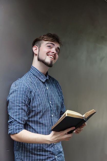 Young man holding a bible, student with ... | Premium Photo #Freepik #photo #book #hand #education #paper Hold Book Pose, Holding Books Reference, Reading Book Pose Reference, Reading Book Reference, Man Holding Book Pose Reference, Holding Open Book Reference, Person Reading Book Reference, Holding Book Pose, Reading Book Pose Drawing Reference