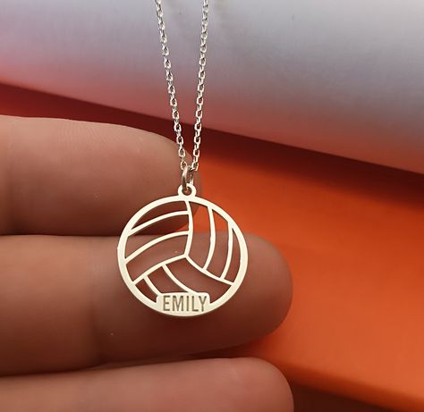 Sport Volleyball pendant in Sterling Silver number and name silver necklace , volleyball name  jewelry, silver sport number, sport mom gift VOLLEYBALL SIZE : 21 MM X 20 MM Metal: 925 Sterling Silver Thickness: approx. 1mm Chain: 925 Sterling Silver The Sport Volleyball Pendant in Sterling Silver is a stylish and personalized necklace that celebrates the passion for volleyball. This custom necklace features a volleyball pendant with the option to engrave a player's number and name, making it a pe Volleyball Necklace Jewelry, Volleyball Gift Ideas, Sport Jewelry, Volleyball Necklace, Volleyball Jewelry, Sports Mom Gifts, Sport Mom, Sport Volleyball, Volleyball Gifts